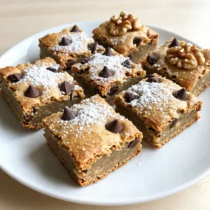To make these tasty blondies, you need the following items: - 1 cup unsalted butter (for browning) - 1 cup packed brown sugar - 1/2 cup granulated sugar - 2 large eggs - 1 teaspoon vanilla extract - 2 cups all-purpose flour - 1 teaspoon baking powder - 1/2 teaspoon baking soda - 1/2 teaspoon salt - 1 cup chocolate chips (semi-sweet or milk chocolate) These ingredients create a rich, buttery base that brings out the flavors. You can add a few extras to make your blondies unique: - 1/2 cup chopped nuts (walnuts or pecans) - Sea salt for sprinkling on top Adding nuts gives extra crunch. A sprinkle of sea salt enhances the sweet taste. If you need to swap some ingredients, here are a few ideas: - Use coconut oil instead of unsalted butter for a dairy-free version. - Substitute brown sugar with coconut sugar for a lower glycemic option. - Use almond flour instead of all-purpose flour for a gluten-free version. These swaps help you create a dish that fits your needs while keeping the taste great. {{ingredient_image_2}} Browning butter is key to adding rich flavor. First, use a medium saucepan. Melt 1 cup of unsalted butter over medium heat. Stir it often. You will see foam start to rise. After about 5 to 7 minutes, the butter will turn golden brown. It will smell nutty and sweet. Remove it from heat and let it cool slightly. This step gives your blondies a warm, deep flavor. Next, we mix the sugars. In a large bowl, combine the cooled brown butter, 1 cup of packed brown sugar, and 1/2 cup of granulated sugar. Use a whisk to blend them well. This creates a smooth and creamy base. After that, add 2 large eggs, one at a time. Whisk well after each egg. Finally, stir in 1 teaspoon of vanilla extract. This adds even more flavor to your blondies. Now, it&rsquo;s time to bake. Preheat your oven to 350&deg;F (175&deg;C). Line an 8x8-inch baking dish with parchment paper. This helps with easy removal later. In a separate bowl, mix 2 cups of all-purpose flour, 1 teaspoon of baking powder, 1/2 teaspoon of baking soda, and 1/2 teaspoon of salt. Slowly add this dry mix to your wet mix. Stir gently until just combined. Do not overmix; this keeps your blondies soft and chewy. Finally, fold in 1 cup of chocolate chips and any chopped nuts you like. Spoon the batter into the prepared dish and spread it evenly. Bake for 25 to 30 minutes. The edges should look golden brown. A toothpick inserted in the center should have some moist crumbs. Let the blondies cool for 15 minutes before lifting them out. Transfer to a wire rack to cool completely before cutting. Enjoy your delicious, chewy treats! When making brown butter blondies, avoid these common slip-ups: - Overheating the butter: Watch it closely. Too much heat will burn it. - Overmixing the batter: Mix until just combined. Overmixing makes them tough. - Using cold eggs: Always use room temperature eggs for better blending. - Skipping the parchment paper: This helps you lift the blondies out easily. For soft and chewy blondies, follow these tips: - Use brown sugar: It adds moisture and a rich flavor. - Don&rsquo;t overbake: Pull them out when a toothpick shows moist crumbs. - Let them cool: Letting them cool in the pan helps them set. - Add chocolate chips: They melt slightly, adding to the chewy texture. Having the right tools makes baking easier and more fun: - Medium saucepan: For browning the butter. - Mixing bowls: Use one for wet and one for dry ingredients. - Whisk: Perfect for mixing sugars and eggs. - Spatula: Great for combining ingredients without overmixing. - 8x8-inch baking dish: Ideal size for the perfect blondies. - Parchment paper: Helps with easy removal and cleanup. Pro Tips Brown the Butter Well: Ensure you watch the butter closely while browning to achieve that rich nutty flavor without burning it. The key is to look for a golden brown color and a pleasant aroma. Don&rsquo;t Overmix: When combining the wet and dry ingredients, mix until just combined. Overmixing can lead to tough blondies, so be gentle! Customize Your Mix-Ins: Feel free to substitute or add different types of chocolate chips, or incorporate dried fruits like cranberries for an extra flavor twist. Store Properly: To keep your blondies fresh, store them in an airtight container at room temperature for up to a week, or freeze for longer storage. {{image_4}} You can change up the flavors in your blondies by adding different mix-ins. Here are some great ideas: - Nuts: Chopped walnuts or pecans add crunch and flavor. - Chocolate: Use dark chocolate chips for a rich taste. You can even mix semi-sweet and milk chocolate for variety. - Fruits: Dried fruits like cranberries or apricots give a sweet twist. - Spices: A pinch of cinnamon or nutmeg can warm up the flavor profile. Have fun experimenting with these options. Each add-in can make your blondies unique! If you want to try something new, here are some creative blondie ideas: - Salted Caramel Blondies: Swirl in some caramel sauce before baking for a sweet and salty treat. - Peanut Butter Blondies: Mix in creamy peanut butter to take your blondies to a new level. - S'mores Blondies: Add mini marshmallows and crushed graham crackers for a campfire classic. These recipes will surprise your family and friends. Everyone loves a good twist on a classic! You can make blondies that fit different diets too. Here&rsquo;s how: - Gluten-Free: Replace all-purpose flour with almond flour or a gluten-free blend. Make sure your chocolate chips are gluten-free. - Vegan: Substitute eggs with flax eggs (1 tablespoon flaxseed meal + 2.5 tablespoons water per egg) and use coconut oil instead of butter. Choose dairy-free chocolate chips for a fully vegan treat. These options ensure everyone can enjoy the deliciousness of blondies. No one will miss the original recipe! To keep your brown butter blondies fresh, store them in an airtight container. Place a piece of parchment paper between layers to prevent sticking. Keep the container in a cool, dry place. Avoid direct sunlight. This method keeps the blondies soft and chewy. You can enjoy them for days without losing texture. For long-term storage, freezing is a great option. First, let the blondies cool completely. Cut them into squares, then wrap each piece tightly in plastic wrap. Place the wrapped blondies in a freezer-safe bag or container. Label it with the date. These can last up to three months in the freezer. When you want to enjoy them, thaw them in the fridge overnight. Brown butter blondies last up to one week when stored properly at room temperature. If you keep them in the fridge, they can last up to two weeks. Always check for freshness before eating. If you notice any changes in smell or texture, it&rsquo;s best to discard them. Enjoy your delicious treats while they are at their best! Brown butter has a rich, nutty flavor. You make it by cooking unsalted butter until it turns golden brown. This process also gives it a deeper taste than regular butter. Regular butter just adds fat. Brown butter adds flavor and depth to your blondies. You'll notice a lovely aroma as it cooks, too. Yes, you can! Brown sugar is crucial for the chewy texture. Granulated sugar helps it spread evenly. You can experiment with other sugars, like coconut sugar or honey. Just know that this might change the taste and texture a bit. Stick to some brown sugar for the best results. To check if your blondies are done, look for golden edges. The center should be set but slightly soft. A toothpick test works well too. Insert it in the middle; it should come out with a few moist crumbs. If it&rsquo;s wet with batter, bake a little longer. You can! To replace eggs, try using unsweetened applesauce or mashed bananas. Use 1/4 cup of either for each egg. This keeps your blondies moist. They might be a bit denser, so adjust your baking time. Try it out for a fun twist on the classic recipe. You learned how to make delicious brown butter blondies with the right ingredients and techniques. Remember to experiment with optional add-ins and substitutions for a unique twist. Avoid common mistakes to get the best texture, and use proper storage methods to keep them fresh. Blondies can be made gluten-free or vegan too. Baking is fun, and these tips will help you create the perfect treat every time. Enjoy your baking journey!
