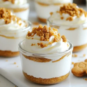 For the No-Bake Gingerbread Cheesecake Cups, you will need the following main ingredients: - 1 cup graham cracker crumbs - 4 tablespoons unsalted butter, melted - 16 ounces cream cheese, softened - 1 cup powdered sugar - 1 teaspoon pure vanilla extract - 1 cup heavy whipping cream - 1/4 cup molasses These ingredients form the heart of the dessert. The graham cracker crumbs create a nice base. Cream cheese gives a rich, creamy texture. Powdered sugar adds sweetness, while vanilla enhances the flavor. Heavy whipping cream lightens the mixture, making it fluffy and delicious. The spices add warmth and depth to your cheesecake cups. You will need: - 1 teaspoon ground ginger - 1 teaspoon ground cinnamon - 1/2 teaspoon ground nutmeg - 1/4 teaspoon ground allspice Ginger is key for that classic gingerbread taste. Cinnamon brings sweetness. Nutmeg adds a hint of warmth. Allspice rounds out the flavors, giving a cozy, festive feel. Toppings make your cheesecake cups eye-catching and tasty. Here are some great options: - Crushed gingerbread cookies - Whipped cream Crushed gingerbread cookies add crunch and flavor. A dollop of whipped cream on top makes each cup look fancy and inviting. You can also sprinkle some cinnamon or nutmeg for extra flair. {{ingredient_image_2}} To start, gather your graham cracker crumbs, melted butter, and spices. In a medium bowl, mix 1 cup of graham cracker crumbs with 4 tablespoons of melted unsalted butter. Add half of the spices: 1 teaspoon of ground ginger, 1 teaspoon of ground cinnamon, 1/2 teaspoon of ground nutmeg, and 1/4 teaspoon of allspice. Stir until the mixture looks like wet sand. This base gives your cheesecake a sweet and crunchy layer. Take a heaping tablespoon of this mixture and press it firmly into the bottom of each cup. Use the back of a spoon to compact it well. Next, it's time for the creamy part. In a large bowl, beat 16 ounces of softened cream cheese with 1 cup of powdered sugar and 1 teaspoon of pure vanilla extract. Use an electric mixer on medium speed. Mix until the cream cheese is smooth and fluffy. Slowly add in 1/4 cup of molasses, mixing until fully combined. This will give your cheesecake that rich gingerbread flavor. Now, let's make it light and fluffy! In a separate clean bowl, whip 1 cup of heavy cream with an electric mixer on high speed. Whip until stiff peaks form, which should take about 2-3 minutes. This step is key for a light cheesecake. Gently fold the whipped cream into the cream cheese mixture with a spatula. Be careful while folding to keep the mixture airy. Stop once no white streaks remain. Using a piping bag or a spoon, fill each cup with the gingerbread cheesecake mixture. Layer it nicely over the graham cracker base. This makes for a beautiful presentation. Aim for a smooth top for each cup. Cover the cups with plastic wrap or foil. Place them in the fridge for at least 4 hours, or better yet, overnight. This allows the cheesecake to set and firm up. Just before serving, sprinkle crushed gingerbread cookies on top. Add a dollop of whipped cream for an extra special touch. Enjoy your delicious creation! To get perfect whipped cream, start with cold heavy cream. Cold cream whips better and faster. Use a clean bowl and beaters to avoid any grease. Whip the cream on high speed until you see stiff peaks. This takes about 2-3 minutes. Don't overwhip; it can turn into butter. Gently fold the whipped cream into your cream cheese mix. Be careful to keep it light and fluffy. Layering is key to making these cups look great. Start with a solid base of graham cracker crumbs. Press it down firmly to hold the cheesecake in place. Use a piping bag to fill the cups with the cheesecake mix. This helps create neat layers. Alternate layers of cheesecake and crumbs for a pretty effect. Finish with whipped cream on top before serving. For a festive look, arrange the cheesecake cups on a colorful platter. Sprinkle some cinnamon or nutmeg on top for flair. Add crushed gingerbread cookies for extra crunch. Use clear cups to show off the layers. This dessert is as tasty as it is pretty, so make it shine! Pro Tips Use Room Temperature Ingredients: Allow the cream cheese and heavy cream to come to room temperature before mixing. This ensures a smoother texture and better incorporation. Chill for Best Results: For the best flavor and texture, let the cheesecake cups chill overnight. This allows the flavors to meld and the cheesecake to firm up perfectly. Experiment with Spices: Feel free to adjust the spice levels to your preference. Adding a pinch of ground cloves or cardamom can give an extra depth of flavor. Garnish Creatively: Besides crushed gingerbread cookies, you can top the cheesecake cups with chocolate shavings or a drizzle of caramel for an elegant touch. {{image_4}} You can switch up the flavors in these cheesecake cups. For a pumpkin spice twist, use pumpkin puree instead of molasses. Add two teaspoons of pumpkin pie spice for that warm, cozy taste. This change will keep the creamy texture while adding seasonal flair. You can also try a chocolate version. Simply mix in cocoa powder and replace some of the powdered sugar with chocolate syrup for a rich delight. To make these cups gluten-free, use gluten-free graham cracker crumbs. You can find these in many stores or make your own from gluten-free cookies. The rest of the ingredients are usually gluten-free. Just double-check your cream cheese and whipped cream labels to ensure they meet your needs. These no-bake cheesecake cups are perfect for holiday gatherings. Serve them on a festive platter for easy sharing. You can even add small spoons next to each cup for fun. For a special touch, sprinkle extra spices on top, like cinnamon or nutmeg. This adds flavor and looks nice. They also work well as party favors. Just place each cup in a small box to take home. To keep your no-bake gingerbread cheesecake cups fresh, cover them tightly. You can use plastic wrap or foil. This helps prevent air from getting in and keeps them creamy. Store the cups in the fridge until you are ready to serve. When stored properly, these cheesecake cups last up to five days in the fridge. They taste best within the first few days after making them. The longer they sit, the softer the graham cracker base may become. You can freeze these cheesecake cups, but keep in mind that the texture may change. To freeze, cover each cup tightly with plastic wrap and then place them in a freezer-safe container. They can last for up to three months. When ready to eat, thaw them in the fridge overnight. Avoid refreezing once they are thawed. Yes, you can make these cheesecake cups ahead of time. I suggest preparing them a day before you plan to serve. This gives them time to chill and set properly. The flavors will also deepen, making them taste even better. Just cover them tightly with plastic wrap and keep them in the fridge until you're ready to enjoy. If you don&rsquo;t have molasses, you can use honey or maple syrup. Both will add a nice sweetness, but they may change the flavor slightly. If you want a darker taste, use dark corn syrup. It will mimic the rich flavor of molasses well. These cheesecake cups need at least 4 hours to set. For the best results, let them chill overnight. This helps the layers firm up nicely. The longer they sit, the better they taste! Absolutely! If you want, you can use other cookies like gingersnaps or chocolate cookies. Just crush them and mix with melted butter like you would with graham crackers. Each type of cookie will give a unique flavor to your cheesecake cups. To whip cream well, start with cold heavy cream. Use an electric mixer on high speed. Whip until stiff peaks form, which usually takes about 2-3 minutes. Be careful not to overwhip, or it may turn grainy. Stop once it looks fluffy and holds its shape well. No-bake gingerbread cheesecake cups are simple and delicious. We covered the key ingredients, steps, and tips to create them perfectly. You can add your favorite flavors or adjust for gluten-free needs. These tasty treats impress at any gathering and are easy to customize. Remember to store them well to enjoy later. Dive into this sweet recipe and share joy with friends and family. Happy baking!